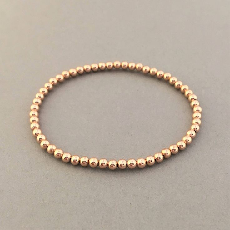 "14k gold fill, rose gold fill, or sterling silver balls are strung onto a stretchy elastic cord. Balls measure 3 mm (approximately 1/8 of an inch). Available as a single bracelet or a set of 3. Great piece to layer! 4mm ball bracelet is here: https://www.etsy.com/listing/694393921/4mm-beaded-ball-bracelet-in-gold-fill 5mm ball bracelet is here: https://www.etsy.com/listing/694396085/5mm-beaded-ball-bracelet-in-gold-fill YOUR ORDER - Choose the number of bracelets you want in the drop-down menu, Dainty Rose Gold Bracelets With Round Beads, Everyday Rose Gold Round Beaded Bracelets, Everyday Rose Gold Beaded Bracelets, Stackable Round Beads Bracelets In Rose Gold, Rose Gold Stackable Stretch Bracelet With Round Beads, Rose Gold Bracelet With Tiny Round Beads, Rose Gold Stackable Bracelet With Round Beads, Dainty Rose Gold Stackable Beaded Bracelets, Hypoallergenic Rose Gold Bracelet With Round Beads