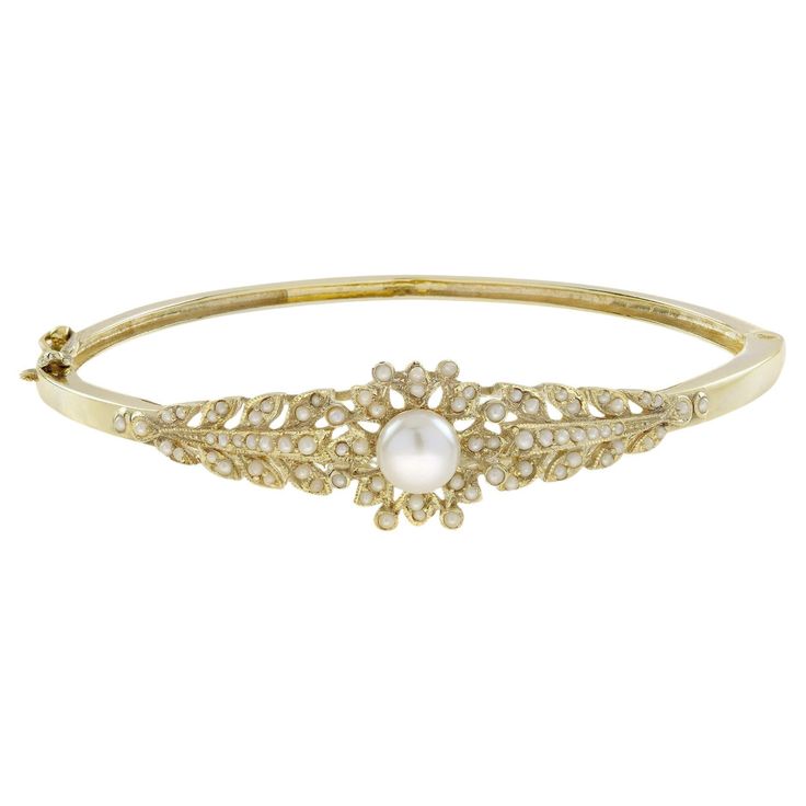 Simply exquisite Victorian era inspired bangle. Hand crafted as unique of solid 14k yellow gold. Charming flower of pearl centered by an approx. 2 carat pearl with further seed pearl chasing the sides. The is the design that a lady of the Victorian period used to wear on her wrist, one of the most desired then and today. Bracelet Information Style: Victorian Metal: 14K Yellow Gold Width: 14 mm. Length:46 mm. Weight: 12.30 g. (approx. in total) Center Gemstones Type: Fresh water Pearl Shape: Roun Victorian Period, Bracelet Box, Fresh Water Pearl, Seed Pearl, 2 Carat, Victorian Era, Victorian Fashion, Bangle Bracelet, Fresh Water