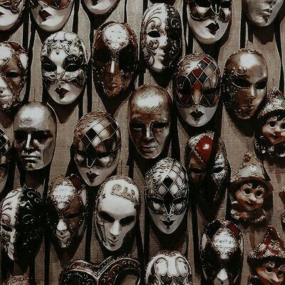 many masks are lined up on the wall