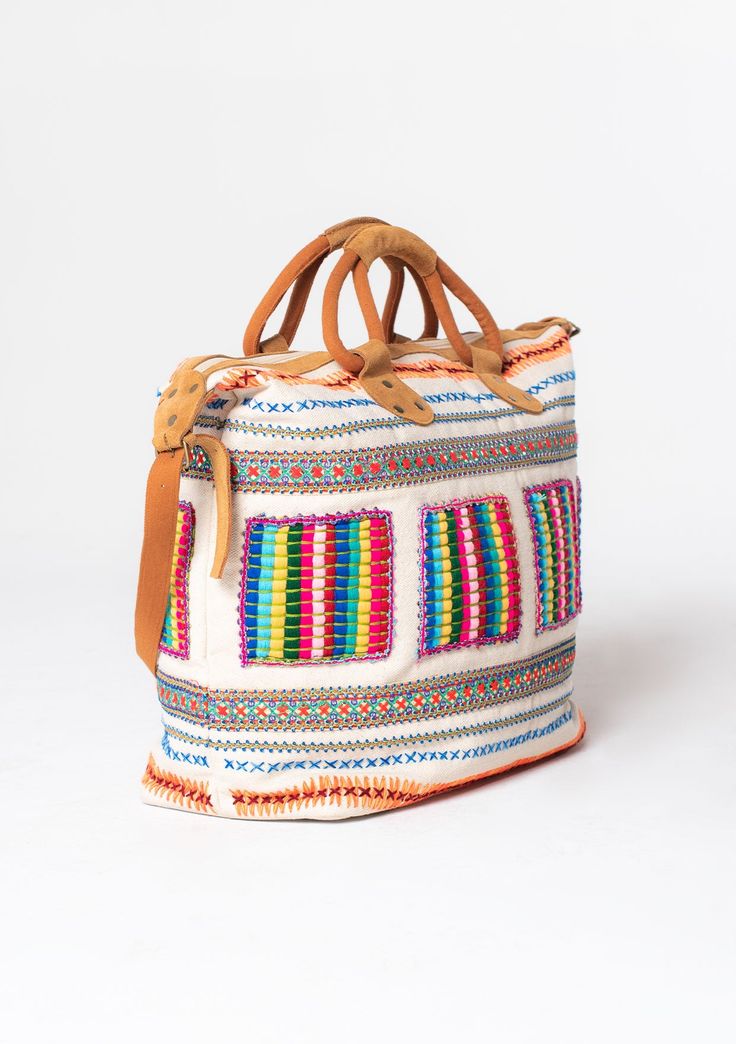 Travel in style with this ultra-bohemian weekender travel bag. A colorful statement piece featuring embroidered details, a zip-top closure, and suede trim. The large carry-all size is perfect for last-minute getaways. Embroidered Stitch details Zip-top closure Suede leather top handles Leather shoulder strap Bohemian weekender bag Dimensions: 24" X 17 3/4"Style: DR-8474 Multicolor Large Capacity Weekender Bag For Trips, Multicolor Rectangular Weekender Bag With Zipper, Multicolor Tote Weekender Bag For Travel, Multicolor Weekender Bag With Zipper For Daily Use, Multicolor Travel Bag With Zipper For Weekend Trips, Bohemian Multicolor Travel Bag For Daily Use, Multicolor Bohemian Travel Bag For Everyday, Bohemian Multicolor Travel Bag, Multicolor Tote Bag For Weekend Trips