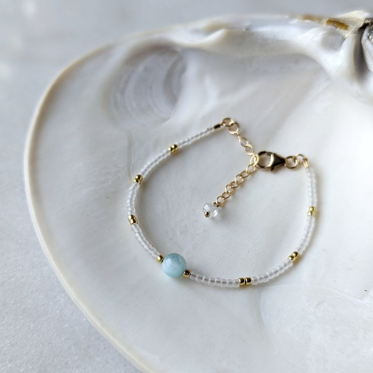 This rare green moonstone gemstones will transport you to the dreamy green waters of a tropical island. They are paired with semi-transparent pearlescent glass beads for the ultimate island look! These are some of my favorite gemstones because the milky aqua color is just too good to be true. SHOP THE MATCHING NECKLACE! Moonstone is one of my favorite gemstones, not just because of its beauty, but because of all the properties it possesses. Known as the stone of inner wisdom, moonstone is great from helping you tap into your intuition. Moonstone helps you stay balanced and true to yourself. Moonstone also helps to support feminine energy. Colors: This beaded bracelet features semi-transparent matte glass beads in the most alluring pearlescent white color Gemstones: Superior AAA Grade *RARE Handmade Elegant Amazonite Beaded Bracelets, Elegant Amazonite Beaded Bracelets, White Jade Beaded Bracelets In Bohemian Style, White Amazonite For Jewelry Making, White Amazonite Jewelry With Natural Stones, White Beaded Amazonite Jewelry, White Moonstone Bohemian Beaded Bracelets, White Amazonite Bracelet With Natural Stones, White Amazonite Bracelets With Natural Stones