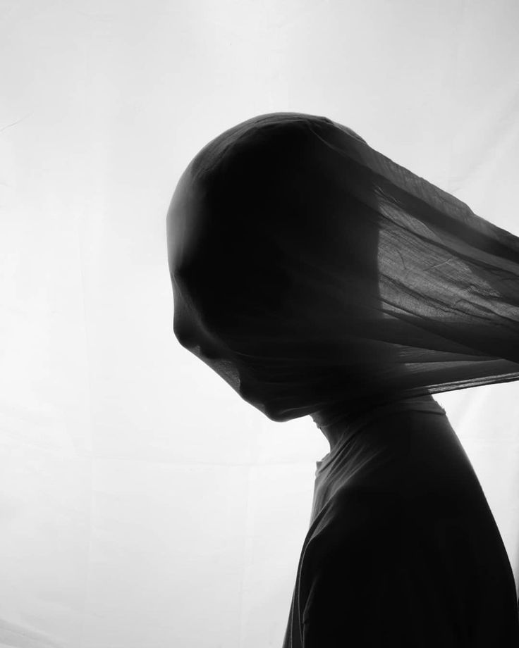 black and white photograph of a woman's head with veil over it