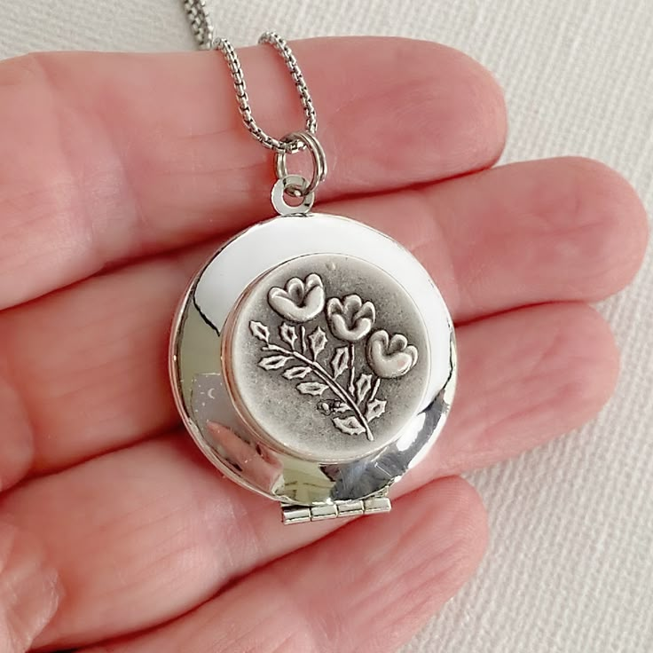 "Introducing my Silver Locket with Forget-Me-Not Flowers, a classic and sentimental piece that will hold a special place in your heart and jewelry collection. This locket features delicate forget-me-not flowers, adding a touch of natural beauty to its timeless design. With a diameter of 27mm (slightly larger than a quarter), it offers ample space to keep your cherished memories close. Crafted from smooth and shiny silver-plated brass, this locket opens to reveal a discreet compartment, perfect f Whimsical Jewelry, Clothes Jewelry, Silver Locket, Style 2023, Prayer Board, Photo Locket, Silver Lockets, Asheville Nc, Forget Me Not