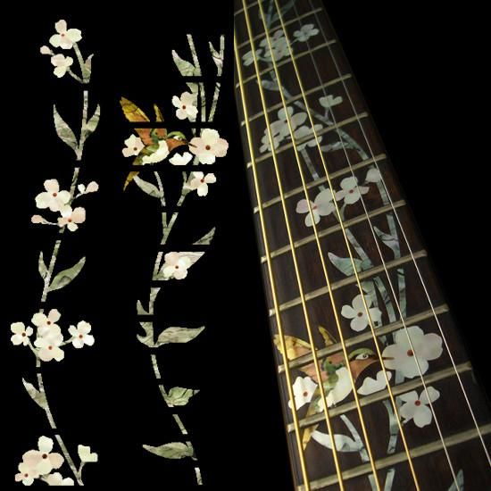 flowers and leaves are painted on the back of an electric guitar, which sits next to it