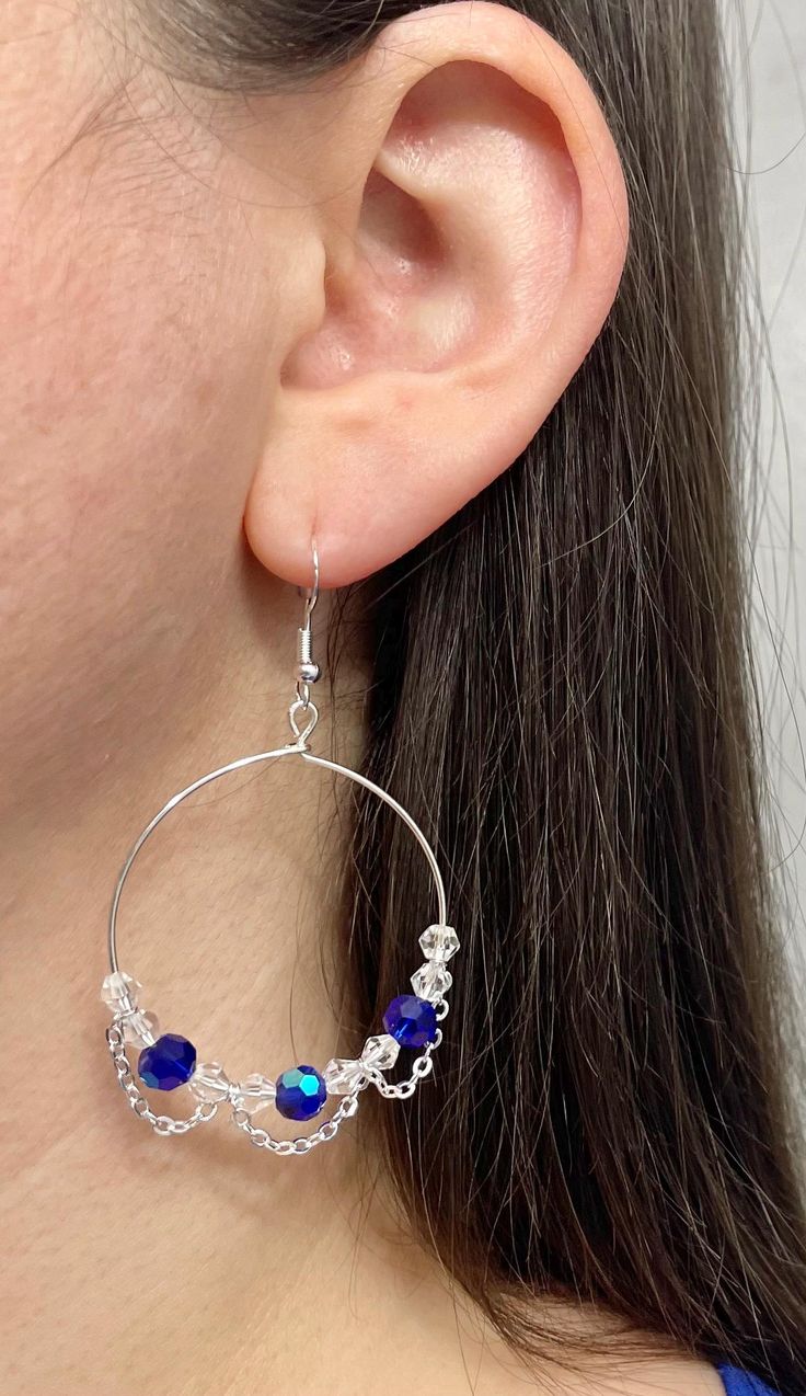 These unique earrings sparkle beautifully and catch the attention of all those around them. Blue Dangle Hoop Earrings, Silver Earrings With Beaded Chain, Trendy Party Jewelry With Dangling Beads, Sterling Silver Beaded Crystal Earrings, Beaded Chain Dangle Party Jewelry, Blue Beaded Chain Dangle Earrings, Small Hoop Earrings With Dangling Beads For Party, Beaded Chain Dangle Jewelry For Party, Blue Hoop Earrings With Dangling Beads Gift