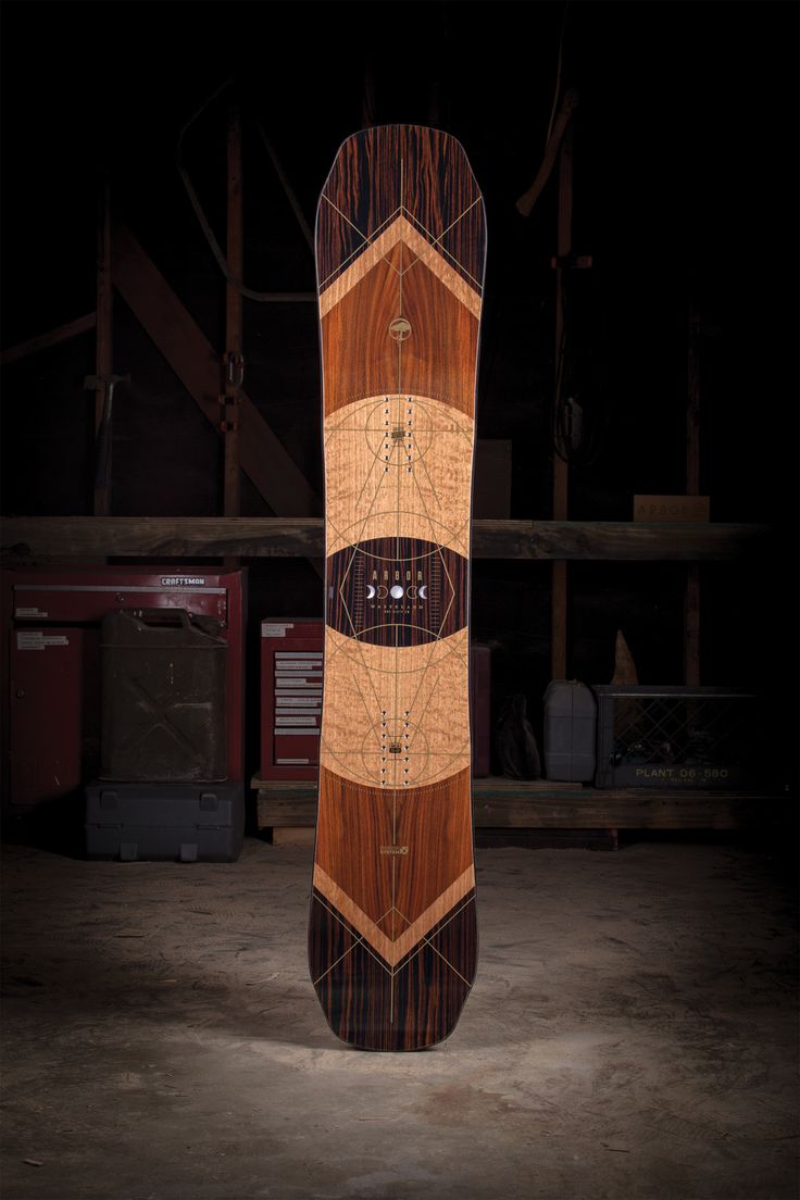 a wooden snowboard sitting in the middle of a room