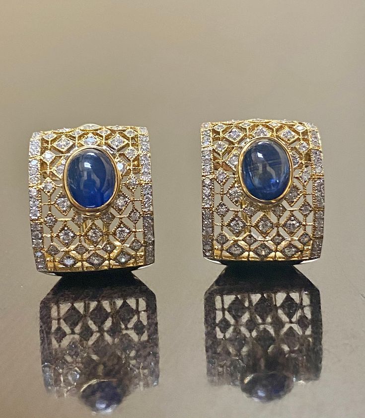 DeKara Designs Collection Metal- 18K White Gold, .750. 15.50 Grams. Stones- 2 Genuine Cabochon Oval Ceylon Blue Sapphires 5.02 Carats, 168 Round Diamonds F-G Color SI2 Clarity 2 Carats. One of a kind entirely handmade, Art Deco 18K Yellow Gold Sri Lanka Ceylon Cabochon Cut Blue Sapphire and Pave Set Diamond Art Deco Inspired One of a Kind Earrings. Each earring has an amazing oval cabochon blue sapphire that is professionally and uniquely bezel/burnish set. There are 79 round pave set diamonds o Luxury Diamond Cabochon Earrings, Luxury Diamond Earrings With Cabochon, Oval Sapphire Earrings With 17 Jewels, Luxury Oval Earrings For Formal Occasions, Luxury Oval Cabochon Gemstone Earrings, Luxury Sapphire Earrings For Formal Occasions, Luxury Formal Sapphire Earrings, Luxury Oval Sapphire Earrings, Luxury Blue Sapphire Earrings