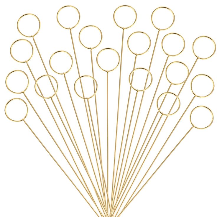 a bunch of gold colored metal circles on a white background