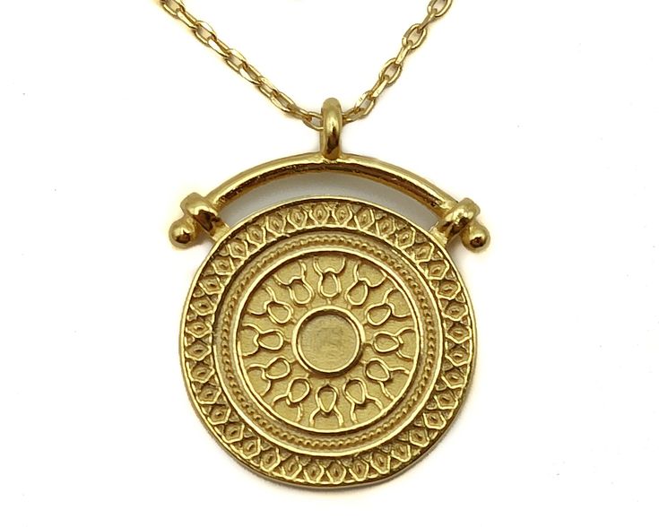 Coin Pendant Charm Necklace ETRURIA is an iconic piece, inspired by the Etruscan relics from the land of Tuscany. The elegant and well-crafted coin has detailed decoration and a unique mount design for a fashionable and timeless vibe. The Etruscans were a dominant culture in central Italy by 650 BC. The Etruria territory, including modern Tuscany, is where they produced fine arts as figurative sculpture in terracotta and Carrara marble, metalworking, and high-quality jewelry.  ♥  Etruria Coin Pendant      Materials: 18k Gold vermeil on sterling silver     Chain lengh: 43 cm     Pendant: 17 mm in diameter ► Thank you so much for visiting our online collection of jewelry pieces of unique design carefully handmade for you. Your bespoke trending layering chains and pendants are here!  https:// Traditional 14k Gold Medallion Necklace, Engraved Yellow Gold Coin Amulet Necklace, Engraved Yellow Gold Coin Necklace, Handmade Yellow Gold Coin Amulet Necklace, Handmade Yellow Gold Amulet Coin Necklace, Handmade Yellow Gold Medallion Necklace In Brass, Spiritual Yellow Gold Brass Coin Necklace, Symbolic Yellow Gold Coin Medallion Necklace, Symbolic Yellow Gold Coin Necklace