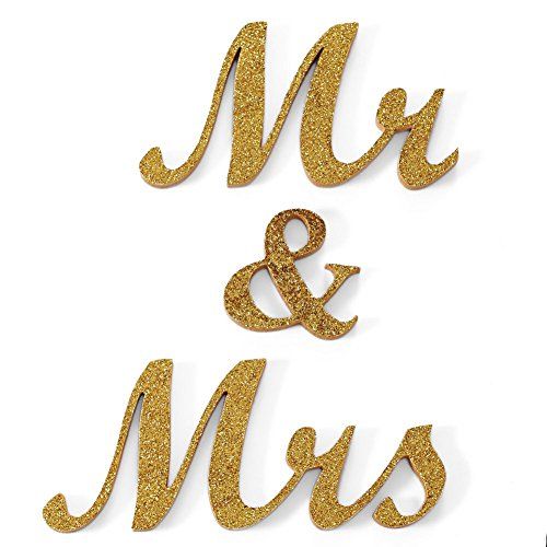 two gold glitter mr and mrs cake toppers on white background with the words mr and mrs