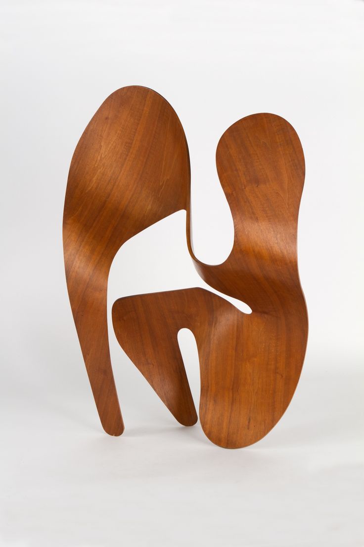 an abstract wooden sculpture on a white background