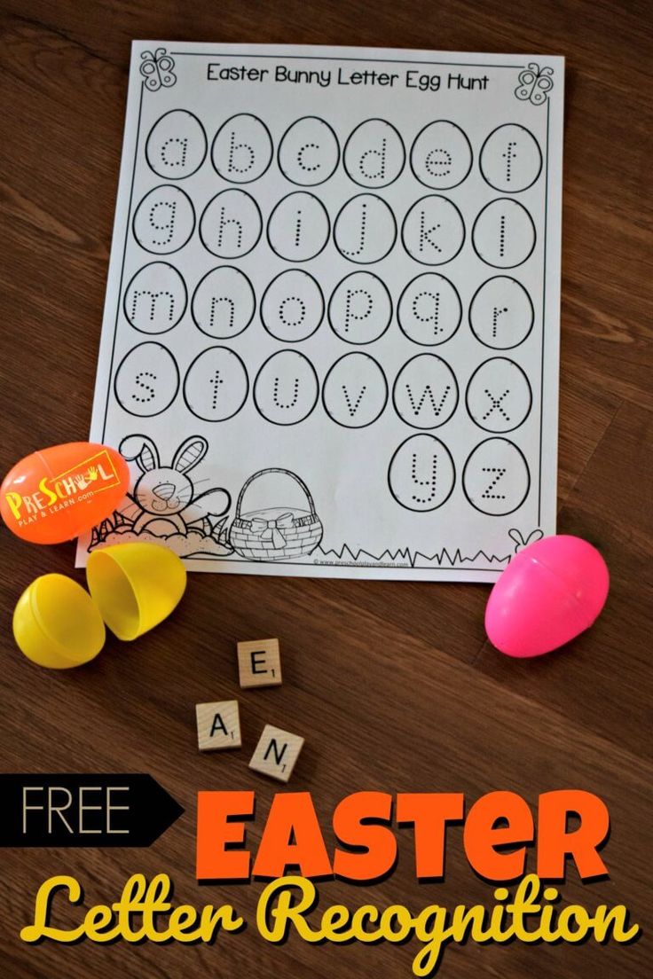 an easter letter recognition game with eggs and candy on the table, next to it