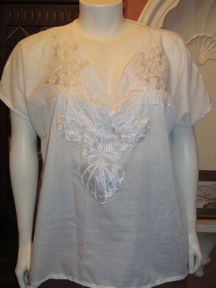 This is a stunning and smart cotton blouse/ Tee with a beautiful embroidered v-neck front, capped sleeves, made in 100" Indian cotton. The measurement details are:- Bust 46"/48" Hips -50"/52" Length - 28" I am a dressmaker that specializes in plus size clothing, lingerie and knitwear As well as Belly Dance wear. I have a made to measure service that is 100% confidential. I cater for all sizes including super sizes. Please visit my facebook page to see examples of my work. www.facebook.com/tighec Elegant Embroidered Cotton V-neck Top, Summer V-neck Blouse With Chikankari Embroidery, White V-neck Blouse With Chikankari Embroidery, Embroidered V-neck Top For Daywear, Cotton V-neck Blouse With Floral Embroidery, Elegant Cotton V-neck Blouse, Elegant White Embroidered Short Sleeve Top, Linen V-neck Blouse With Floral Embroidery, V-neck Linen Blouse With Floral Embroidery