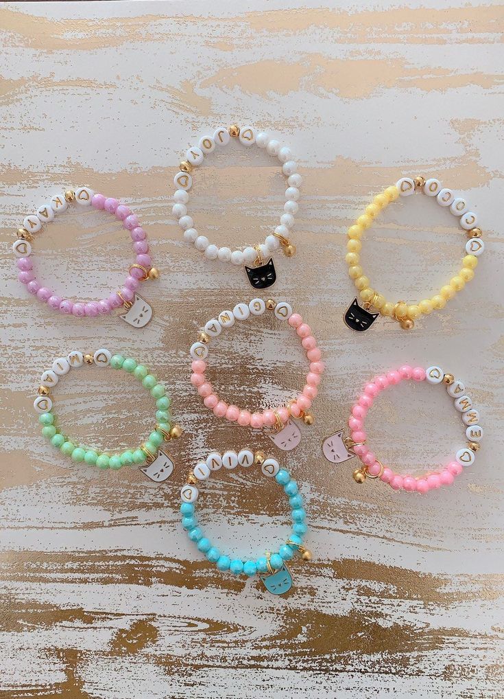 "Adorable 🐱kitty charm bracelets for all your cat lovers!! Bracelet is perfect for anyone any occasion! All orders come with 1 custom name beaded bracelet mixed with 24K gold bell charm and a kitty charm of your choice! You will have 7 colored beads and 4 different colored kitty charm to choose from. How to order: 1. Please select the bracelet size from the first drop down 2. Please select the bead color of your choise 3. In the personalization box - please enter the name you would like to plac Cute Round Beaded Bracelets For Birthday, Cute Charm Bracelet With Letter Beads For Birthday, Cute Name Bracelet With Round Beads For Everyday, Cute Birthday Charm Bracelet With Letter Beads, Cute Everyday Name Bracelet With Round Beads, Kawaii Hypoallergenic Jewelry For Birthday, Kawaii Hypoallergenic Jewelry For Birthdays, Cute Hypoallergenic Charm Bracelet For Birthday, Personalized Kawaii Jewelry For Birthday