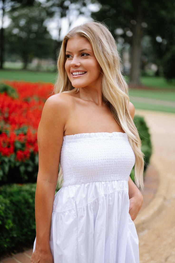 This stunning Lotus Dress in White features a strapless design with a smocked top for a flattering fit. It hits at a stylish midi length and is complete with functional pockets for added convenience. The waist seam detail adds a touch of elegance to this versatile dress that is perfect for any occasion. 100% cotton Not lined Model is 5'6" with a 34" bust, 27" waist, and 36" hips wearing a size small Size rec: S 0-4 M 4-6 L 8-10 Lotus Dress, Loungewear Summer, Smocked Top, Dresses By Length, Versatile Dresses, Top Sales, Short Rompers, Set Dress, Midi Length