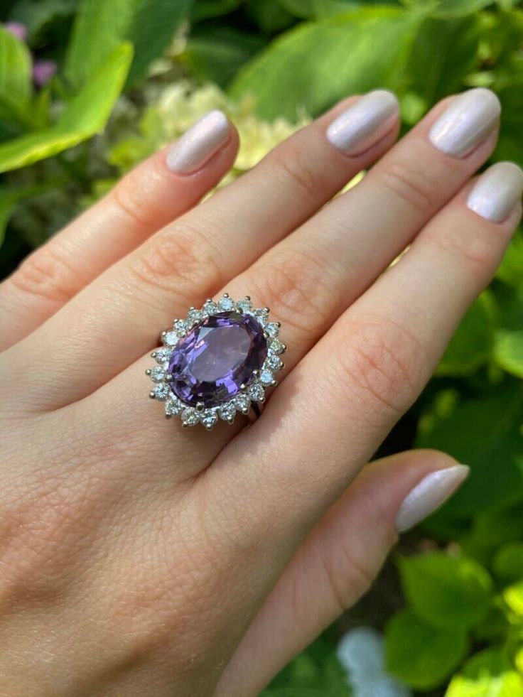 Introducing our exquisite 18k White Gold Ring with Amethyst and Natural Diamonds, a true symbol of elegance and luxury. Crafted with utmost precision and attention to detail, this stunning ring is the perfect accessory to elevate your style and make a statement. This ring is made from high-quality 18k white gold and has a sophisticated design that effortlessly complements any outfit or occasion. The centerpiece of this masterpiece is a mesmerizing amethyst gemstone, known for its vibrant purple Elegant Luxury Purple Crystal Ring, Luxury Purple Oval Crystal Ring, Luxury Amethyst Ring With Brilliant Cut Diamond, Luxury Amethyst Diamond Ring With Brilliant Cut, Luxury White Gold Amethyst Ring, Luxury Purple Gemstones With Halo Setting, Luxury White Gold Amethyst Ring With Diamond, Luxury Silver Amethyst Ring, Luxury Purple Amethyst Ring With Halo Setting