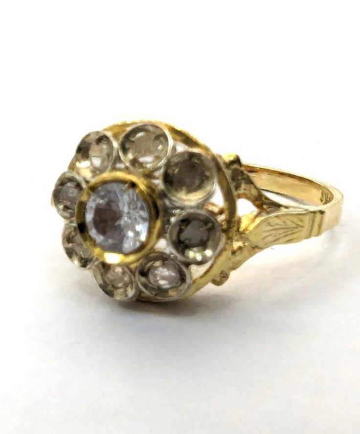 A 9 carats yellow gold italian vintage ring. Hall marked 9 kt on the back inside of the ring. weight: 3.3 grams size N uk crown : 10.00x10.00mm coronet pink cut diamonds, estimated at 0.40 kt estimated brillian cut blue topaz 0.40 kt perfect for an anniversary occasion Anniversary Yellow Gold Flower Ring With Single Cut Diamonds, Antique Gold Signet Ring With Rose Cut Diamonds, Victorian Sapphire Ring With Diamond In Gold, Victorian 14k Gold Diamond Cut Rings, Victorian Yellow Gold Rings With Rose Cut Diamonds, Victorian Gold Sapphire Ring With Diamond, Antique Yellow Gold Sapphire Ring With Rose Cut Diamonds, Gold Rings With Rose Cut Diamonds In 14k Gold, Heirloom Gold Engraved Ring With Rose Cut Diamonds