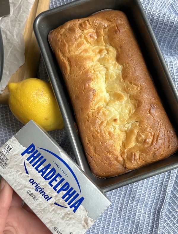 a loaf of bread sitting on top of a pan next to a box of lemonade