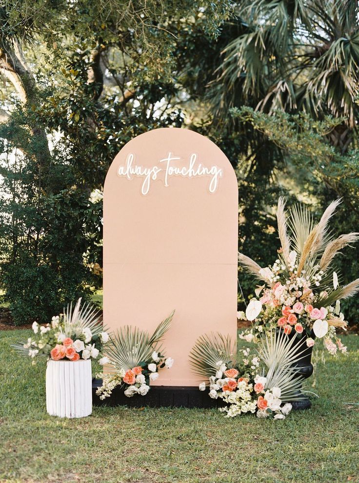 an outdoor wedding ceremony setup with flowers and greenery