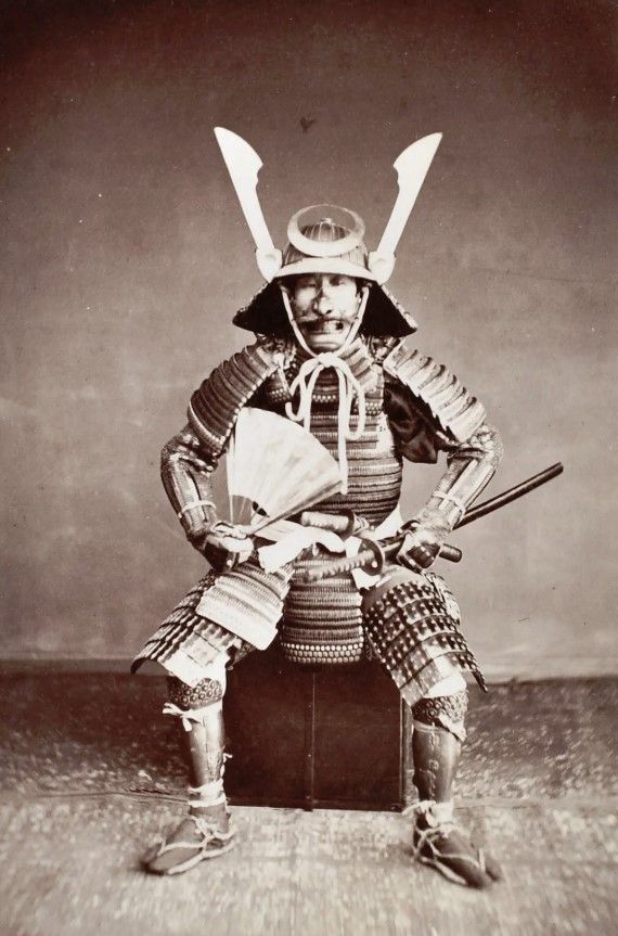 an old black and white photo of a samurai