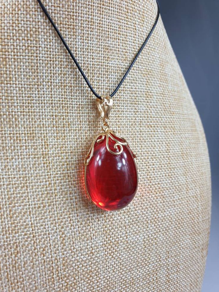 Deep Red amber pendant. Perfect stunning ruby red teardrop shape. Gold plated pendant (with stamping-hallmark). High quality. Teardrop shape elegant pendant. All natural parts, not plastic. Weight: 14.00 gr Pendant size: 5.5 x 2.6 cm MATCHING Earrings: https://www.etsy.com/uk/listing/912802337/ruby-red-amber-earrings-gold-plated?ref=shop_home_active_4&frs=1 This item was made of natural Baltic Amber. All the amber used in my jewelry is collected in my home country Lithuania. I sell only genu Formal Teardrop Cabochon Necklace, Amber Teardrop Cabochon Necklace, Formal Jewelry With Cabochon Teardrop Pendant, Formal Cabochon Teardrop Pendant Jewelry, Formal Teardrop Pendant Jewelry With Cabochon, Formal Teardrop Cabochon Pendant Jewelry, Amber Teardrop Cabochon Jewelry, Red Drop Beads For Jewelry Making, Red Teardrop Gemstone Drop Necklace