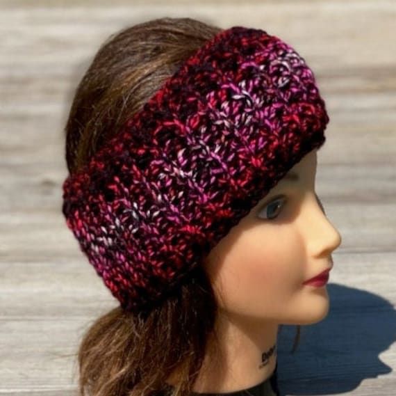 a close up of a mannequin head wearing a knitted hat