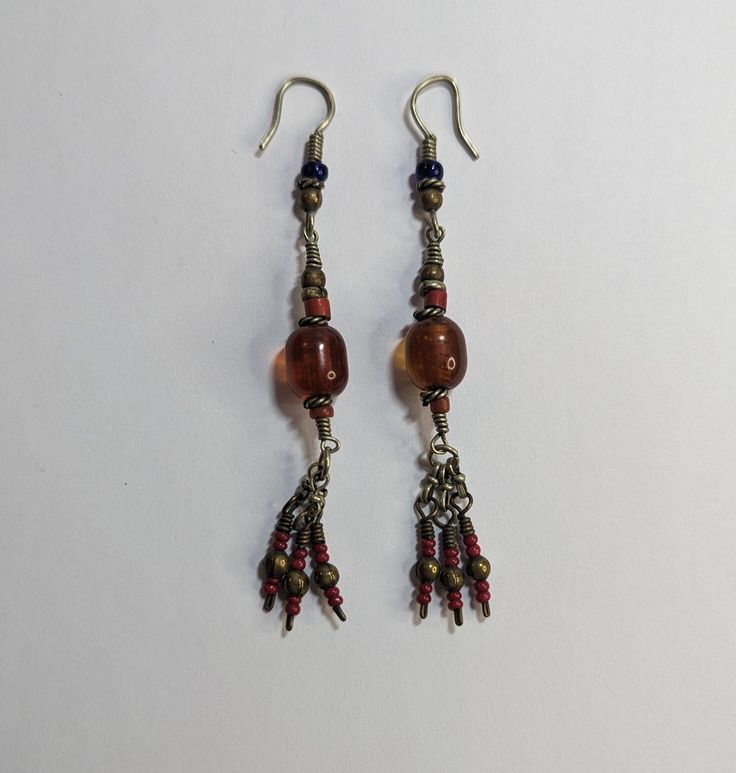 Vintage Handmade Artisan Beaded Earrings Dangle Drop Brown Red Glass Beads Twisted Wire Details 3" Tassel Ends Approximately 3" long Dangle Earrings With Silver Beads For Festivals, Silver Beaded Dangle Earrings For Festivals, Festival Dangle Earrings With Silver Beads, Red Traditional Beads For Crafting, Traditional Red Beads For Crafting, Traditional Large Beaded Earrings For Gifts, Dangling Beads For Gifts And Festivals, Handmade Traditional Metal Beads, Artisan Colorful Dangle Beads