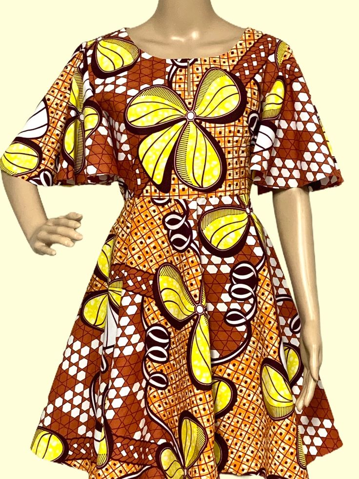 Step into the vibrant rhythms of Africa with this stunning handmade dress adorned in bold, colorful African prints. Crafted with care and attention to detail, this dress celebrates the rich heritage and culture of the continent while adding a touch of contemporary flair to your wardrobe. Whether you're strolling through the city streets or attending a special event, this unique piece is sure to turn heads and spark conversations. Embrace the spirit of Africa and express your individuality with this eye-catching ensemble. Handmade with love! Vibrant Multicolor Short Sleeve Mini Dress, Retro Multicolor A-line Dress, Yellow Short Sleeve Dress With Vibrant Print, Fitted Multicolor Ankara Fabric Dress, Fitted Multicolor Ankara Dresses, Bohemian A-line Multicolor Dress, Colorful Printed Vibrant Dresses, Vibrant Orange Printed Dress, Vibrant Multicolor Floral Print Dresses