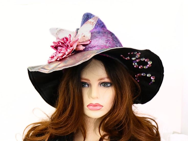 Ready for a costume, the Renfair, a festival, a Salem visit - this size small triple goddess moon witch hat is one of a kind. A shorter point with style and character already built in. The color is a blend of purples and pinks with a silk overlay for depth. A moth is clipped to the matching flower and can be removed when desired. The rhinestones underneath the brim pay tribute to the Triple Moon Goddess. The wired brim has an iridescent upper, with black underneath and can be shaped to any angle you prefer. I felted the material for this hat by hand, with deep dyed fine merino and silk, so it is full of visual texture, lightweight, and soft to wear. Felting gives this hat natural water resistance so you don't have to worry about the weather. Can be folded flat for travel. -This soft witchy Whimsical Multicolor Costume Hat For Kentucky Derby, Whimsical Wide Brim Costume Hat, Fantasy High Crown Hat For Costume Party, Whimsical Multicolor Hat For Kentucky Derby, Whimsical Multicolor Kentucky Derby Costume Hats, Whimsical Wide Brim Fitted Costume Hat, Whimsical Fitted Wide Brim Costume Hat, Whimsical Top Hat For Halloween, Handmade Curved Brim Costume Hats And Headpieces