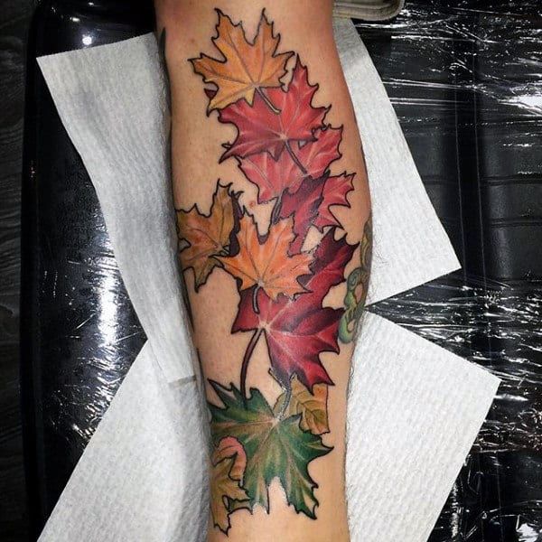 a leaf tattoo is shown on the leg