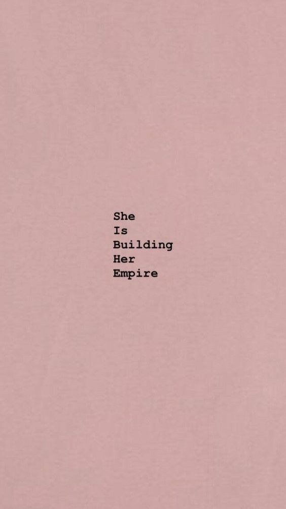 the words she is building her empire written in black on a pink background