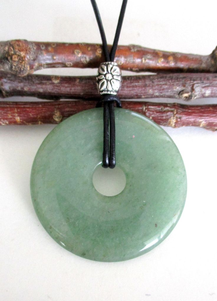 "Green Aventurine Natural Semi-Precious Gemstone Donut Shape Energy Pendant Necklace.  ED598 / ED598-A -50mm / ED637-40mm / ED302-30mm ED598 - Measures approx. 50 x 8mm = 2\" x ¼\".    ED598-A - Measures approx. 50 x 8mm = 2\" x ¼\".  Has small natural markings. ED637 - Measures approx. 40 x 7mm = 1 ½\" x ¼\".  Suspended on a continuous 31\" black leather cord strand without a clasp closure and accented with a silver tone Tibetan style bead. ED302 - Pendant measures approx. 30 x 7mm = 1 ¼\" x ¼\ Donut Pendant Necklace, Donut Necklace, Green Aventurine Necklace, Music Academy, Random Clothes, Donut Pendant, Green Aventurine Crystal, Aventurine Necklace, Aventurine Crystal