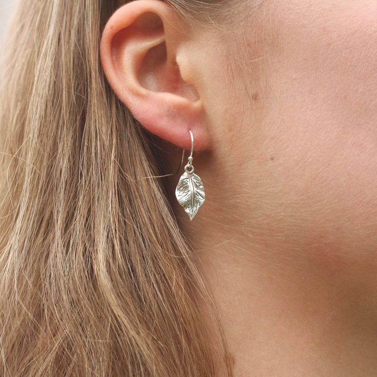 These earrings feature beautifully detailed sterling silver leaves that have a gorgeous shine to them. The leaves are about 17mm long and about 10mm wide with a lovely rippled texture. The earrings dangle a little over an inch from the sterling silver ear wires and are very lightweight and comfortable. The minimalist nature-inspired design of these will make them everyday favourites. More leaf and nature-themed jewelry can be found here: www.etsy.com/ca/shop/juliegarland/search?search_query=natu Sterling Silver Leaf Earrings With Ear Wire, Nickel-free Leaf-shaped Sterling Silver Earrings, Hypoallergenic Sterling Silver Leaf-shaped Earrings, Nature-inspired Leaf-shaped Earrings, Silver Leaf-shaped Minimalist Earrings, Silver Leaf Minimalist Earrings, Minimalist Sterling Silver Leaf-shaped Earrings, Minimalist Silver Leaf Earrings, Minimalist Leaf-shaped Sterling Silver Earrings