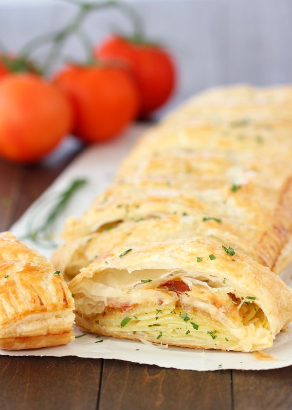 an omelet is cut in half and sitting on a napkin next to tomatoes