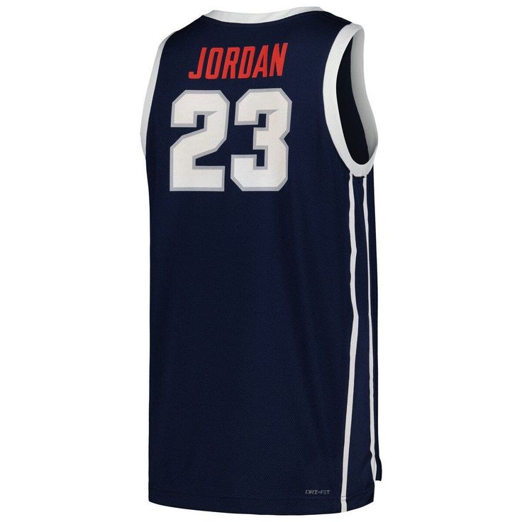 Celebrate Howard University's partnership with Jordan Brand with this Michael Jordan Replica Basketball Jersey. Along with the Howard Bison graphics and colors, this jersey also features MJ's name and number and is constructed with Dri-FIT fabric technology for a sporty feel. The perfect blend of team spirit, style and comfort, this jersey is the great way to elevate your collection of gear. Replica Jersey Droptail hem with side splits Machine wash, line dry Dri-FIT technology wicks away moistur Navy Jersey For Sports Events, Navy Team Name Jersey Tops, Collegiate Jersey For Sports Season Team Events, Collegiate Style Jersey For Sports Season Events, Collegiate Team-colored Jersey With Graphic Print, Navy Jersey Top For Sports Season, Navy Tops With Team Logo For Team Events, Sporty Navy Tops For Team Events, Navy Jersey Tops For Sports Events