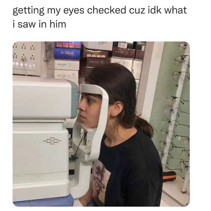 a woman looking through a machine with the caption getting my eyes tested because i'm failing to see your point