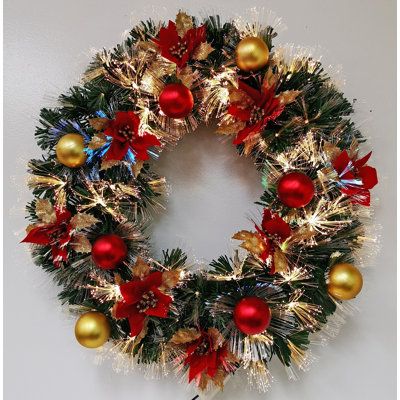 a christmas wreath with red and gold ornaments