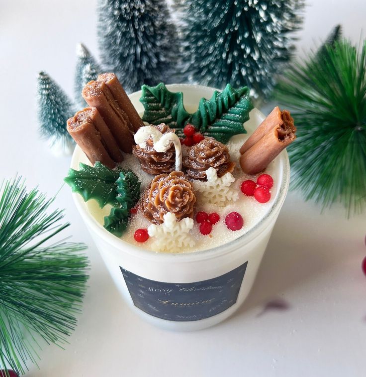 a cup filled with food next to christmas trees