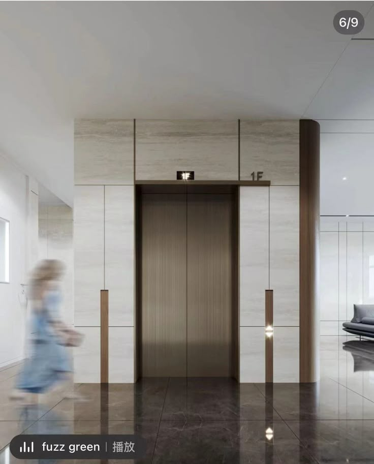 a woman is walking in front of an elevator