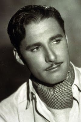 a black and white photo of a man with a mustache