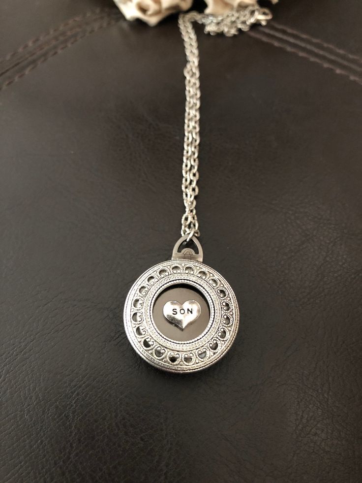 "🔸🔸orders are delayed by a few days this week. Thank you for your patience Son photo locket necklace, keepsake necklace This antiqued silver locket has been adorned with an antiqued silver SON charm which sets in a detailed antiqued silver bezel. This small folding spring locket is 1\" and can hold four small 3/4\" photos and hangs from 20\" of antiqued silver textured rhodium chain and lobster clasp. You can also purchase additional chain by the inch for a longer necklace during checkout. I c Personalized Sterling Silver Locket Necklace For Memorial, Personalized Locket Necklace For Mother's Day Memorial, Personalized Sterling Silver Locket Necklace For Mom, Personalized Silver Locket Necklace For Memorial, Personalized Spiritual Locket Necklace For Anniversary, Sterling Silver Locket Necklace For Mom, Sterling Silver Locket Necklace Gift For Mom, Personalized Silver Locket Necklace Keepsake, Personalized Silver Locket Necklace For Mom