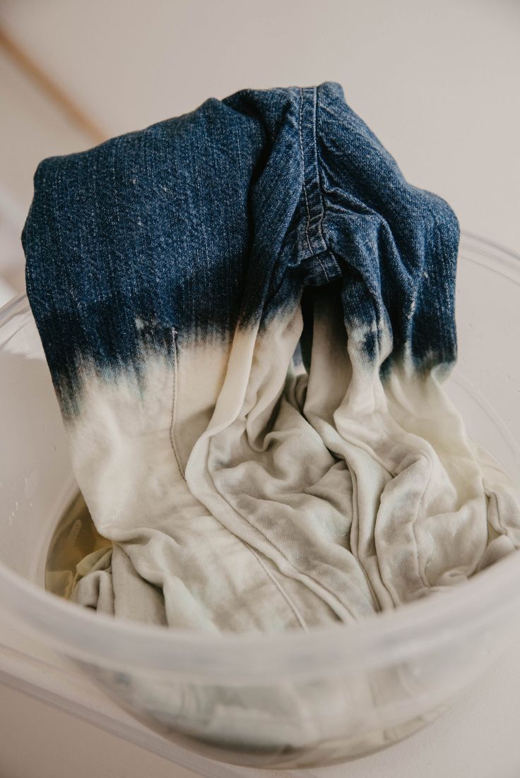 a blue and white cloth in a plastic container