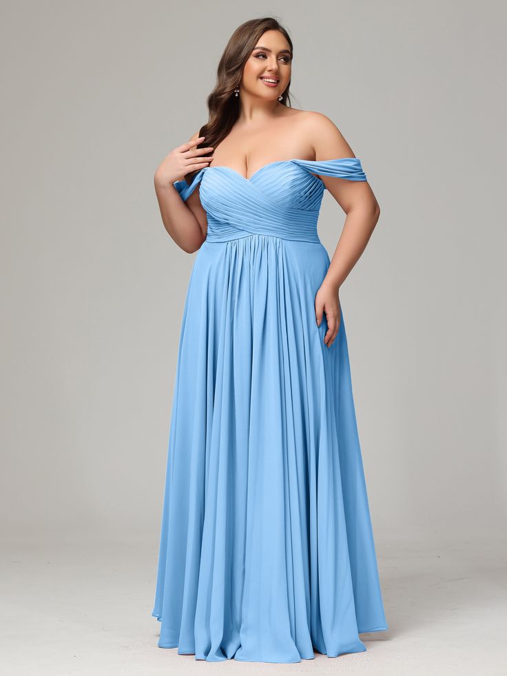 a woman in a blue dress posing for the camera with her hands on her hips