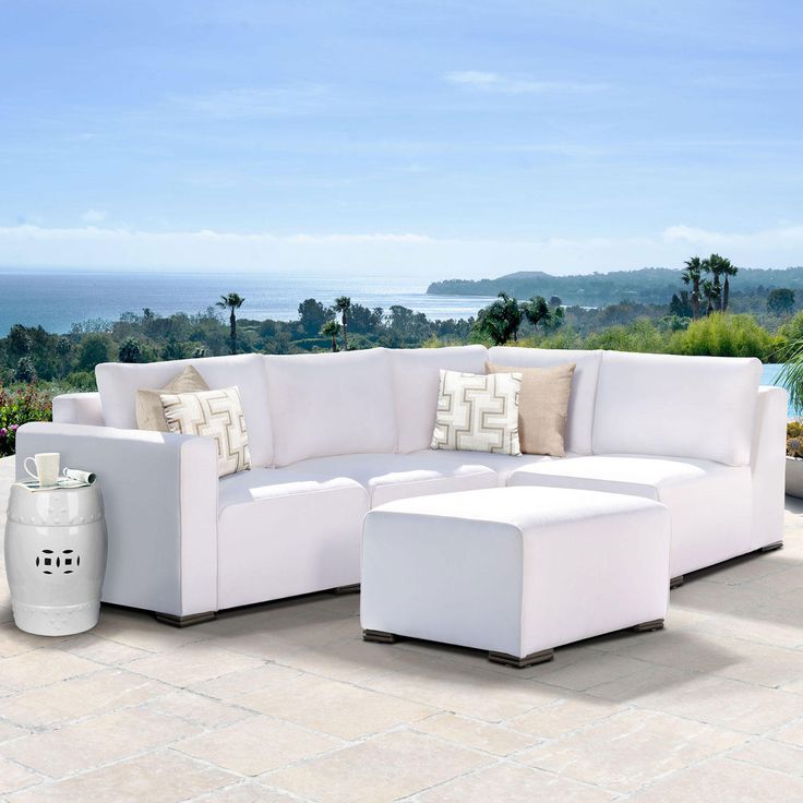 a large white couch sitting on top of a patio