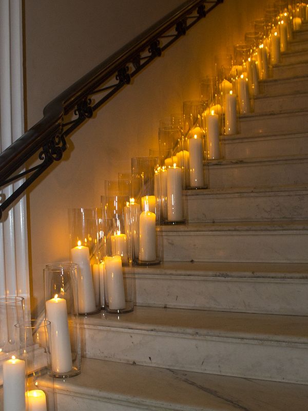 many candles are lit on the stairs