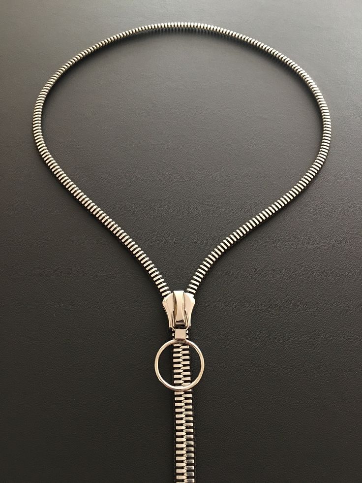 Discover the seamless blend of style and functionality with our unique necklace. Boasting sleek lines and a smooth glide, this piece is designed for effortless elegance. Forget about fumbling with tricky clasps. With our innovative design, you just need to unzip and wear it. It's as simple as that. This necklace not only adds a touch of sophistication to your attire but also offers a hassle-free experience. Experience the ease of elegance. Unzip, wear, and let your style statement speak volumes. With our necklace, fashion is not just about looking good; it's about feeling good too. - High polished metal - Zipper teeth are plated in nickel (silver) in color - Slider, zipper ring pull and bottom stop is shiny nickel - Approximately 20 inch drop from back of neck - When zipped up the width is Modern Interchangeable Jewelry For Everyday Wear, Modern Everyday Jewelry With Interchangeable Details, Modern Everyday Jewelry With Interchangeable Features, Modern Everyday Interchangeable Jewelry, Modern Adjustable Snake Chain Jewelry, Modern Adjustable Snake Chain Necklaces, Modern Jewelry With Interchangeable Round Pieces, Elegant Everyday Metal Jewelry, Modern Interchangeable Round Jewelry