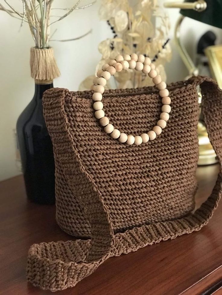 "\"Elevate your summer style with our Women's Raffia Crossbody Bag! Crafted from natural straw and featuring a round wooden handle, it's a perfect accessory for city outings. Upgrade your seasonal fashion now! 🌞👜\"" Eco-friendly Crossbody Crochet Beach Bag, Eco-friendly Crochet Crossbody Bag For Beach, Eco-friendly Crossbody Crochet Bag For Beach, Natural Crossbody Crochet Bag For Beach, Natural Crochet Crossbody Bag For Beach, Brown Crochet Crossbody Bag For Beach, Natural Straw Pouch Bag For Beach Season, Brown Woven Beach Bag With Round Handle, Eco-friendly Beige Crochet Bag With Round Handle