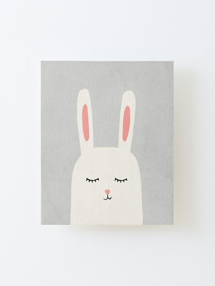 a white rabbit with pink ears on it's face and eyes are drawn in the shape of a bunny