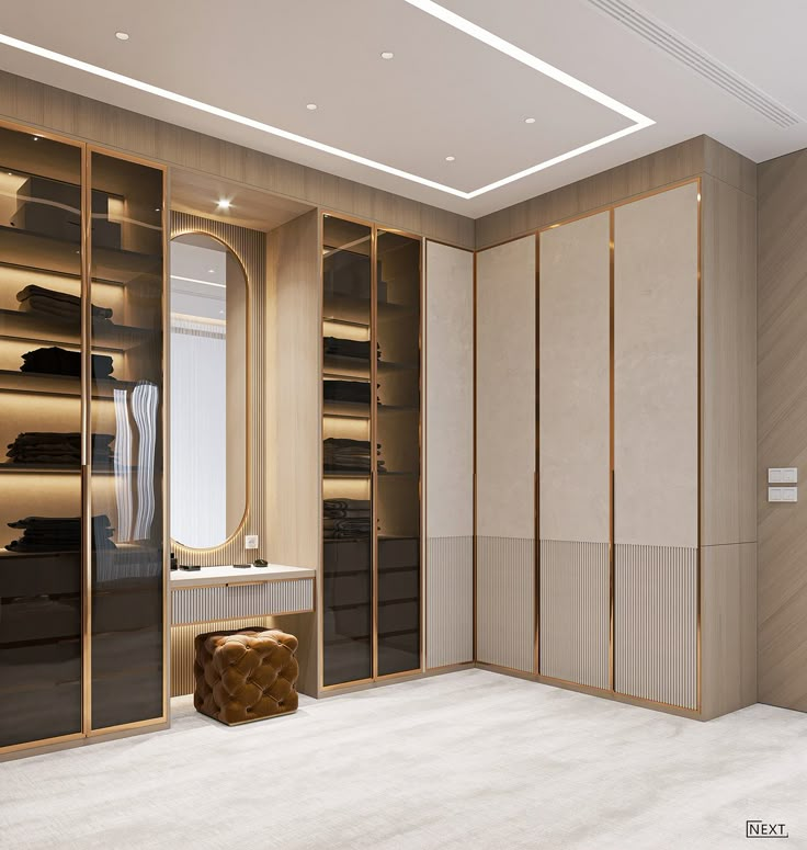 an empty walk - in closet with mirrored doors and gold trimmings, is shown