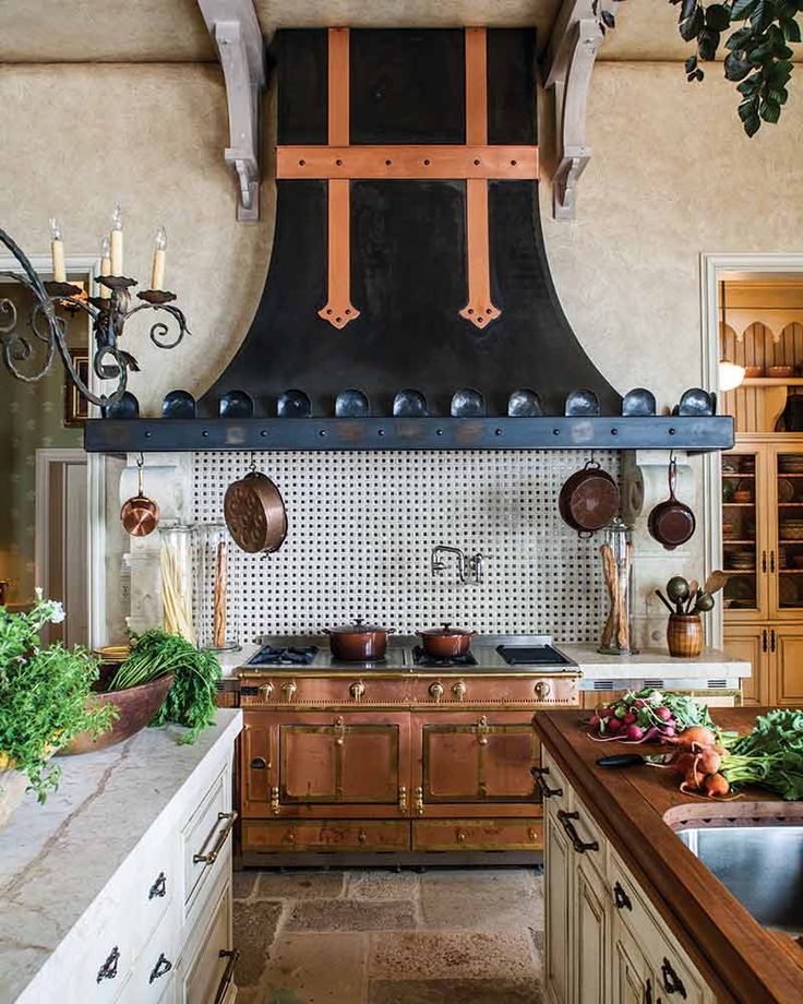 a kitchen with lots of counter space and hanging pots on the wall above the stove